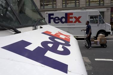 In this Tuesday, Aug. 22, 2017, photo, FedEx trucks are parked in New York.