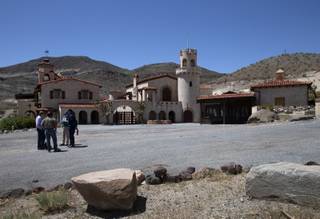 Officials gather near the main house at Scotty's Castle in Death Valley National Park Thursday, May 2, 2019. Scotty's Castle has been closed since a massive flood on October 18, 2015 caused extensive damage to utilities, buildings, and the road way. The attraction is expected to reopen in 2020.