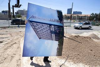Eric Weis, a marketing and advertising executive with CAI Investments, carries an artist's illustration of the hotel exterior during a CAI Investments groundbreaking ceremony for a new Delta Hotel by Marriott at the southwest corner of Flamingo Road and Valley View Boulevard Wednesday, June 26, 2019.