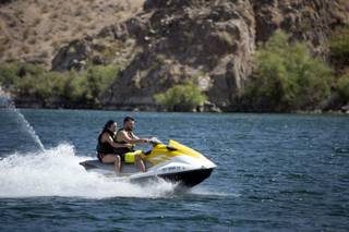 A couple rides on a jet ski at Willow Beach, Ariz. in the Lake Mead National Recreation Area Saturday, July 13, 2019.