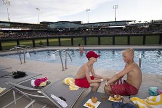 Reed Hawkins, left, and Dax Kunz, both 14, enjoy the outfield pool at Las Vegas Ballpark as the Aviators play the Salt Lake Bees Thursday, July 11, 2019.