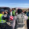 A Nellis Air Force Base airman was killed in a single-car crash near Indian Springs July 17, 2019.  Nevada Highway Patrol troopers and a military member salute the American-flag-draped body of the victim.
