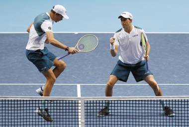 Bob Bryan, left, and Mike Bryan celebrate winning their doubles tennis match Nov. 13, 2017, at the ATP World Finals against Jamie Murray of Britain and Bruno Soares of Brazil at the O2 Arena in London.