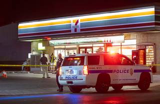 A Metro Police car is shown by a 7-Eleven convenience store after a Henderson Police officer shot a robbery suspect in the arm near Boulder Highway and Barrett Street Tuesday, Aug. 6, 2019.