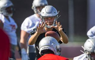 UNLV quarterback Kenyon Oblad (7) takes a snap during practice at Rebel Park at UNLV Friday, Aug. 2, 2019.