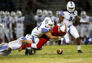 Liberty High School's Edward Gastelum (4) fumbles the ball as he is tackled by Chandler (Ariz.) High School's Kyler Orr during a game in Henderson Friday, Aug. 23, 2019.