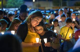 Veronica Robles, sister of Mark Garcia, and her daughter Jazmyn, 17, console each other during a candlelight vigil for Mark and his daughter Monet, 12, outside the SoBe Ice Arena at Fiesta Rancho in North Las Vegas Tuesday, Sept. 17, 2019. The father and daughter were killed in a traffic accident Friday night.