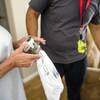 A customer receives a delivery of medical marijuana at her home July 12, 2017. The MedMen cannabis company has begun a 24-hour delivery service in Southern Nevada.