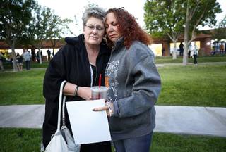 Shooting survivors Heidi Dupin, lett, of Las Vegas, and Michelle Eisenberg of Chino Hills, Calif. embrace before a 1 October Sunrise Remembrance ceremony at the Clark County Government Center Tuesday, Oct. 1, 2019. The ceremony marked the second anniversary of the Oct. 1, 2017 mass shooting in Las Vegas.