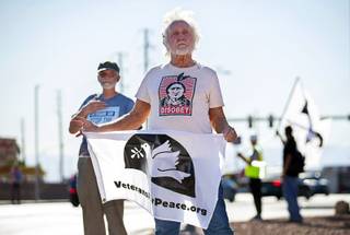 George Killingsworth, center, of Berkeley, Calif. pickets with Fred Bialy, left, of San Francisco at the main entrance to Nellis Air Force Base Thursday, Oct. 3, 2019. Veterans for Peace, Code Pink, and other groups are opposed to a plan that would expand the Nevada Test and Training Range into the Desert National Wildlife Refuge.