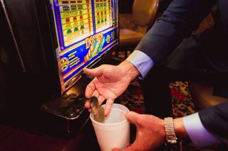General Manager Adam Wiesberg demonstrates winnings from a coin operated slot machine at El Cortez Casino Wednesday, Oct. 2, 2019.
