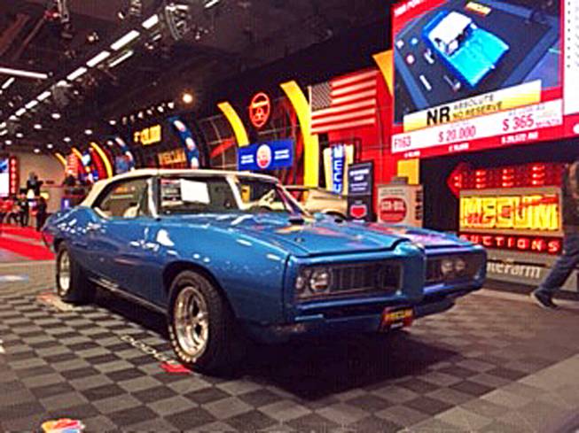 A Pontiac GTO rolls through the auction line Friday, Oct. 11, 2019, during the Mecum Auctions third-annual Las Vegas sale at the Las Vegas Convention Center. The three-day auction concludes today.
