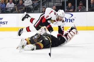 Vegas Golden Knights goaltender Marc-Andre Fleury (29) defends against Ottawa Senators center Chris Tierney during the first period of an NHL hockey game Thursday, Oct. 17, 2019, in Las Vegas.