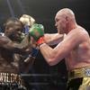 In this Dec. 1, 2018, file photo, Tyson Fury, right, of England, connects with Deontay Wilder during a WBC heavyweight championship boxing match in Los Angeles.