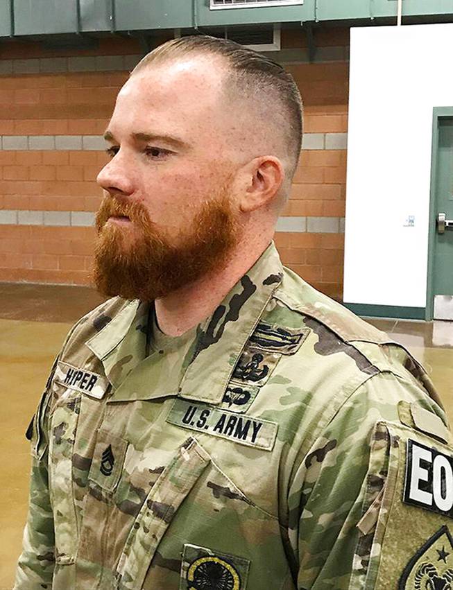 This August 2019 photo provided by the Nevada Army National Guard shows Sgt. 1st Class Benjamin Hopper of the Nevada Army National Guard at a deployment ceremony in Nevada. Hopper, who is serving in Afghanistan, received a uniform religious exemption to sport a beard based on his Norse pagan beliefs. He is the first guard soldier to receive a religious accommodation for a beard.