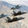 In this Sept. 3, 2015, file photo, F-35C Lightning IIs, attached to the Grim Reapers of Strike Fighter Squadron (VFA) 101, and F/A-18E/F Super Hornets attached to the Naval Aviation Warfighter Development Center (NAWDC) fly over Naval Air Station Fallon's (NASF) Range Training Complex near Fallon, Nev. The U.S. Navy has concluded no significant environmental harm would result from its proposed tripling of the size of a Nevada bombing training range opposed by neighboring tribes, conservationists and at least one Democratic presidential candidate. 