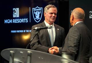 Jim Murren, left, chairman and CEO of MGM Resorts International,shakes hands with Marc Badain, president of the Las Vegas Raiders, during a news conference at Mandalay Bay Thursday, Jan. 23, 2020. MGM Resorts International announced a founding partnership with the Las Vegas Raiders.