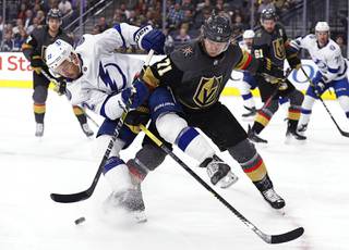Tampa Bay Lightning defenseman Kevin Shattenkirk (22) and Vegas Golden Knights center William Karlsson (71) become entangled during the first period of an NHL hockey game Thursday, Feb. 20, 2020, in Las Vegas.