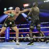 Tyson Fury, left, of England, hits Deontay Wilder during a WBC heavyweight championship boxing match Saturday, Feb. 22, 2020, in Las Vegas.