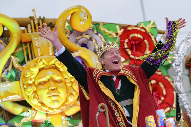 Actor Bryan Cranston waves beads as he acts as the celebrity monarch of the Krewe of Orpheus along the Uptown parade route during Mardi Gras celebrations in New Orleans, Monday, Feb. 24, 2020. 