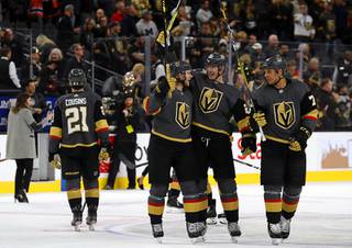 Vegas Golden Knights center William Karlsson (71), defenseman Nick Holden (22), and right wing Ryan Reaves (75) celebrate after the Golden Knights shut out the Edmonton Oilers, 3-0, at T-Mobile Arena in Las Vegas Wednesday, Feb. 26, 2020.
