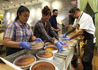 From left, server Fatima Zaldana, server Caity Many and Chef Todd Harrington put lids on to-go orders of corn bread at Honey Salt in Summerlin, Thursday, March 19, 2020. Honey Salt is continuing to provide to-go orders amid the COVID-19 quarantine period.