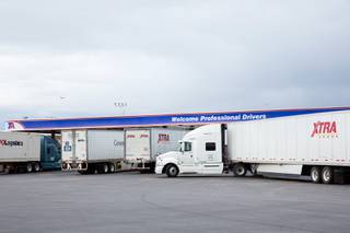 Semi-trailer trucks pull into the TA Truck Stop on Dean Martin Drive and Blue Diamond Road, Monday April 6, 2020.