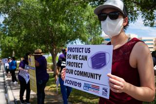 Healthcare workers stand in front of MountainView Hospital protesting over unsafe working conditions during the COVID-19 pandemic, Thursday April 30, 2020.