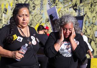 Jennie Ruiz, left, of Porterville, Calif. walks with Marie Cofinco of Dove Canyon Calif. after Cofinco is overcome with emotion during a news conference in front of Jammyland Cocktail Bar & Reggae Kitchen Saturday, June 6, 2020. Both women had family members who were killed by police. The news conference and march in the Arts District were organized by families in partnership with Forced Trajectory Project.