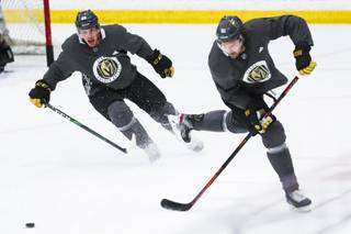 Vegas Golden Knight Mark Stone (61) and Nate Schmidt (88) chase the puck during practice at City National Arena, Monday, July 13, 2020.