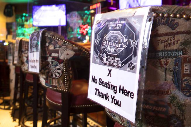 Bar stools are marked with "no seating" signs at Steiner's Nevada-style Pub on West Cheyenne Avenue Friday, July 24, 2020. 