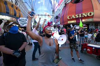 Keke Bolton, center, and other protesters chant  at the Fremont Street Experience during a march, organized to honor Breonna Taylor and other people killed by police, in downtown Las Vegas Saturday, Sept. 5, 2020. Taylor was shot and killed by Louisville (Kentucky) Metro Police officers on March 13, 2020.