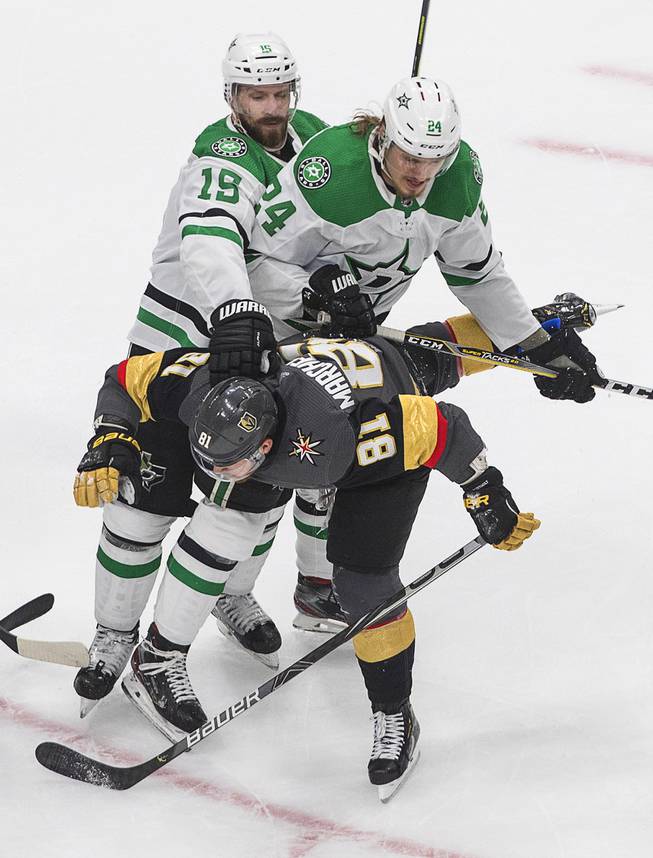Dallas Stars' Blame Comeau (15) and Roope Hintz (24) rough up Vegas Golden Knights' Jonathan Marchessault (81) during the second period of Game 2 of the NHL hockey Western Conference final, Tuesday, Sept. 8, 2020, in Edmonton, Alberta.