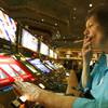 In this Dec. 28, 2005, file photo, Judy King of Daytona Beach, Fla., holds her cigarette while playing a slot machine at the MGM Grand in Las Vegas.