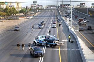 Las Vegas Metro Police investigators and crime scene analysts work the scene of an apparent road rage homicide on I-15 southbound between Spring Mountain and Flamingo roads Wednesday, Sept. 16, 2020.