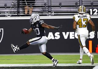 Las Vegas Raiders running back Jalen Richard (30) celebrates in the end zone for a touchdown in the second half of the Raiders' first home game against the New Orleans Saints at Allegiant Stadium Monday, Sept. 21, 2020. New Orleans Saints free safety Marcus Williams (43) is at right.