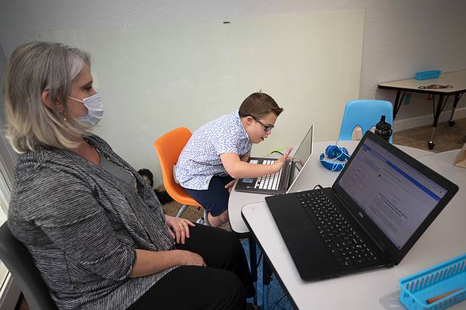 Wendy Broder of NEAT Services watches as Cooper Adams, 10, completes some schoolwork during the official opening of the Collaboration Center at LV Ranch Thursday, Sept. 24, 2020. The new campus will provide support services, therapy, group classes and recreation to individuals with disabilities.