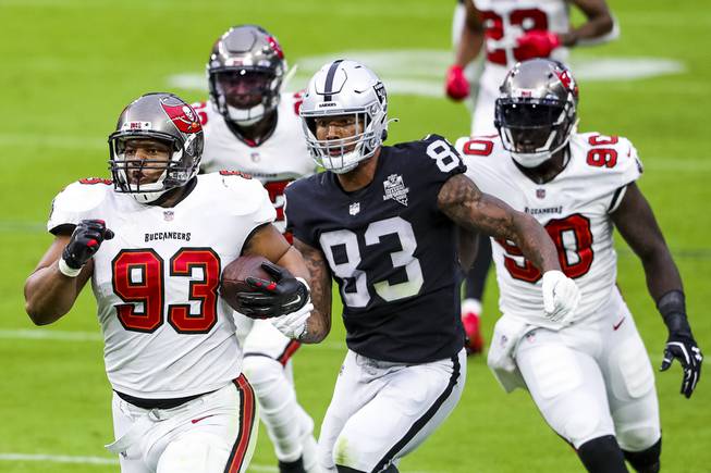 Tampa Bay Buccaneers defensive end Ndamukong Suh (93) returns a fumble as Las Vegas Raiders tight end Darren Waller (83) attempts to chase him down during a game at Allegiant Stadium, Sunday, Oct. 25, 2020.