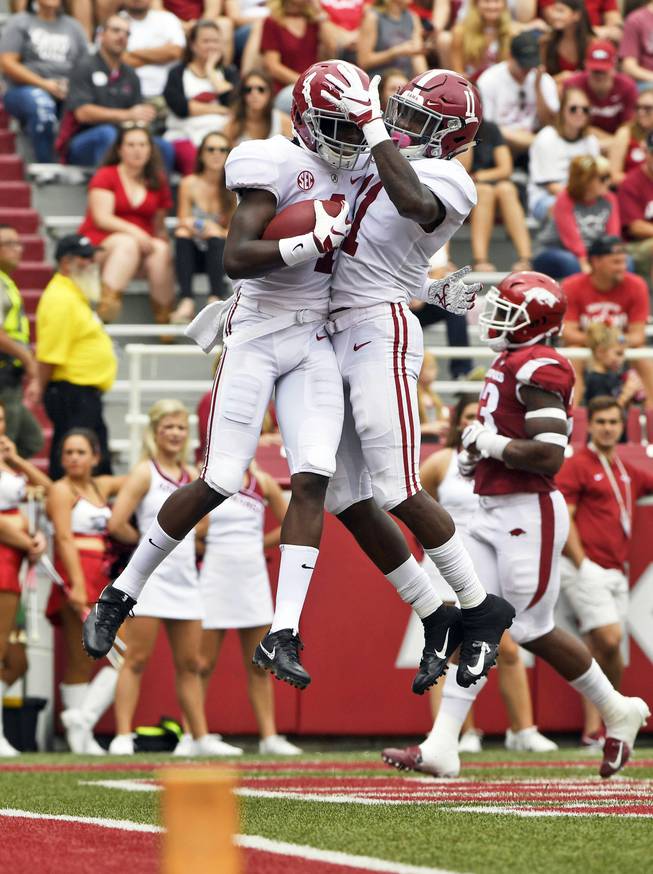Alabama receiver Jerry Jeudy, left, celebrates with teammate Henry Ruggs III (11) after scoring a touchdown against Arkansas in the first half of an NCAA college football game Saturday, Oct. 6, 2018, in Fayetteville, Ark.
