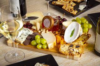 A cheese board by Valley Cheese & Wine Cheesemonger Diana Brier with Brie Gres, Gouda, Adarre, Angico Brazilian Acacia Honey, Dried Cranberry, Dark Chocolate Disks, Apricots, Grapes, Macadamia Nuts, Cherries, Almonds and Crisp Bread Friday, July 17, 2020.