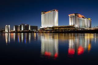 Laughlin’s Edgewater Casino, Aquarius Casino and Riverside Casino are reflected in the Colorado River, Friday, Dec. 4, 2020.