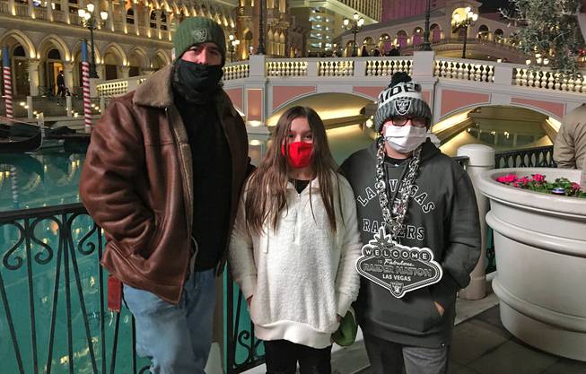 Californian Johnny DiMatteo, shown with his children Gianna and Gino, pose in front of the Venetian Thursday, Dec. 31, 2020.
