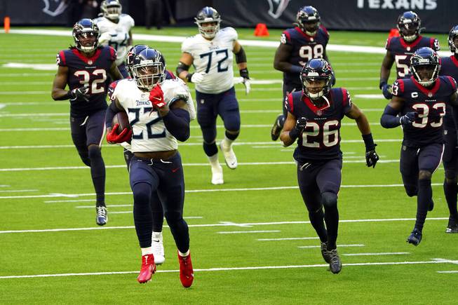 Tennessee Titans running back Derrick Henry (22) runs for a touchdown as Houston Texans defends chase him during the first half of an NFL football game Sunday, Jan. 3, 2021, in Houston. 