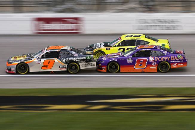 Daniel Hemric (8) rides the bumper of Noah Gragson (9) in the first lap of a NASCAR Xfinity Series auto race at Kansas Speedway in Kansas City, Kan., Saturday, Oct. 17, 2020. 