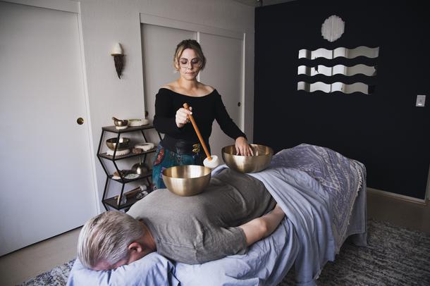 Vibrational Sound Therapist Carey-Sue Kaplan demonstrates a sound therapy session on a model Thursday, April 29, 2021.