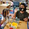 Photo: Teacher Juliana Urtubey, right, works with A'Real Photo: Teacher Juliana Urtubey, right, works with A'Real