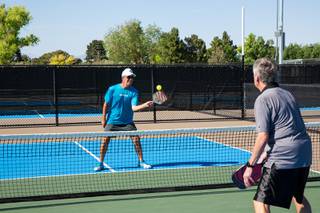 Scott Whitehead, USA Pickleball Association district ambassador for Southern Nevada, and Brien Vokits, of the Southern Nevada Pickleball Club and USA Pickleball Association ambassador, play a quick demonstration match at the new Sunset Park Pickleball Complex Thursday May 6, 2021.