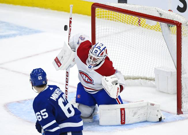 Montreal Canadiens goaltender Jake Allen (34) makes a save as Toronto Maple Leafs forward Ilya Mikheyev (65) looks for the rebound during the second period of an NHL hockey game Saturday, May 8, 2021, in Toronto. 