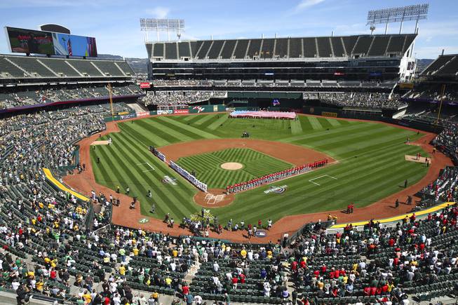 The Los Angeles Angels and Oakland Athletics stand for the national anthem at the Oakland Coliseum prior to an opening day baseball game in Oakland, Calif., in this Thursday, March 29, 2018, file photo.
