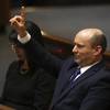 Photo: Israel's new prime minister Naftali Bennett raises Photo: Israel's new prime minister Naftali Bennett raises